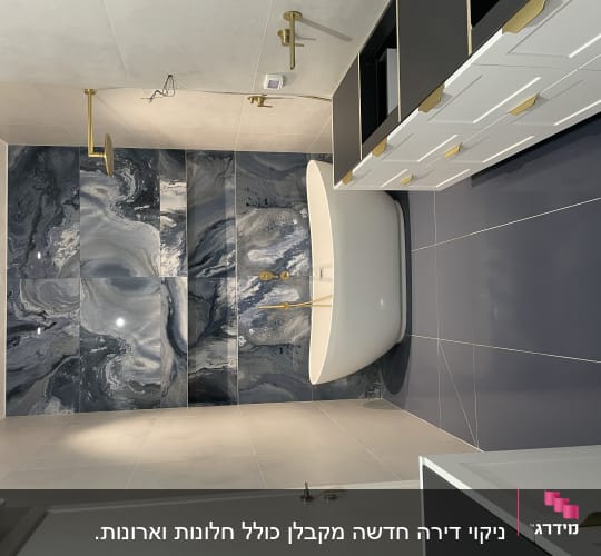 אמבטיה לבנה על רקע קיר שיש כחול
